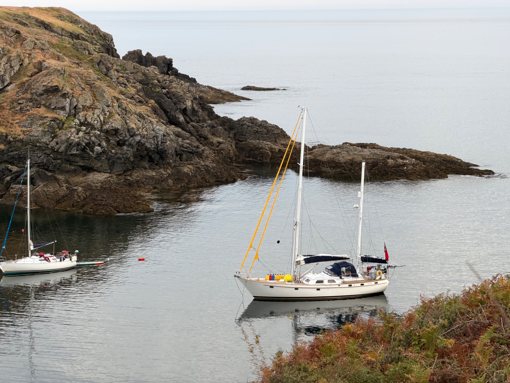 Juna at anchor in a sheltered rocky cove
